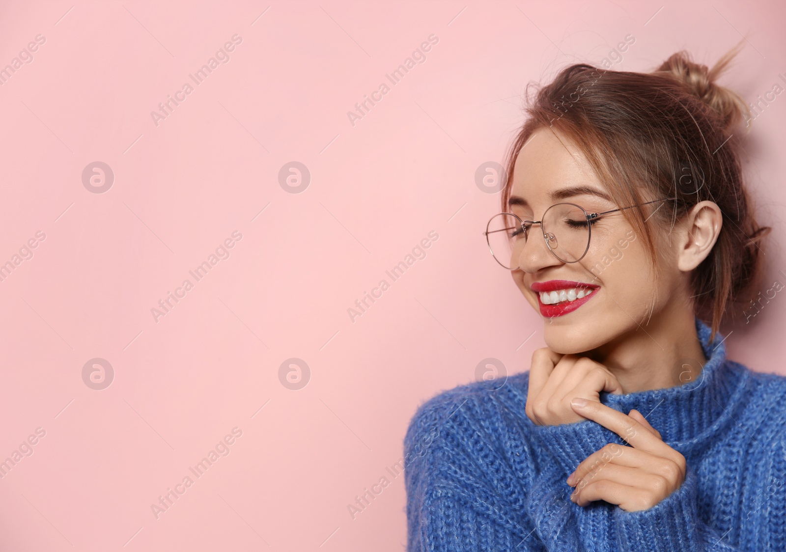 Photo of Beautiful young woman in warm sweater on color background. Space for text