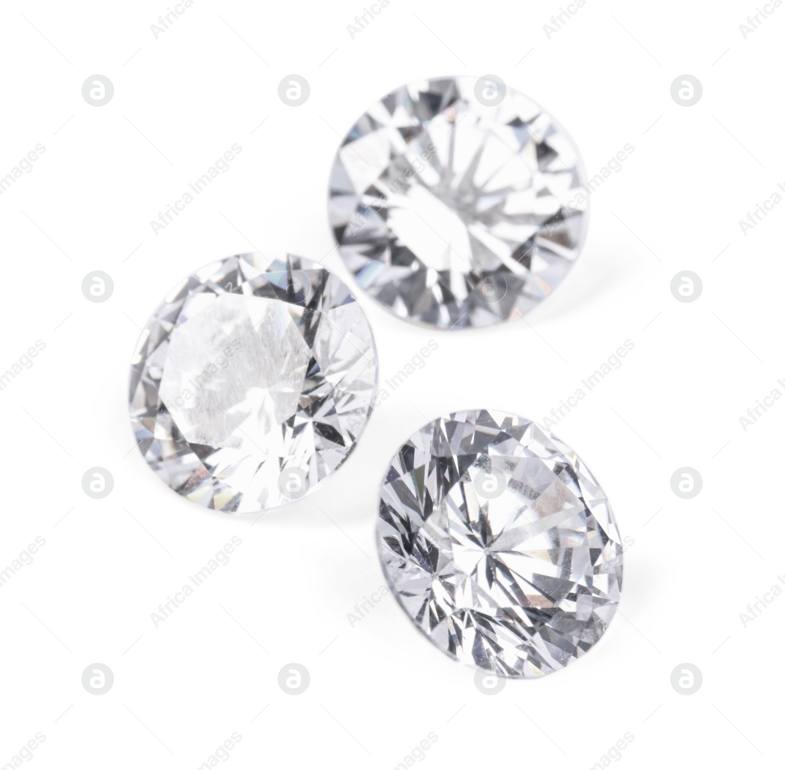 Photo of Three beautiful shiny diamonds isolated on white