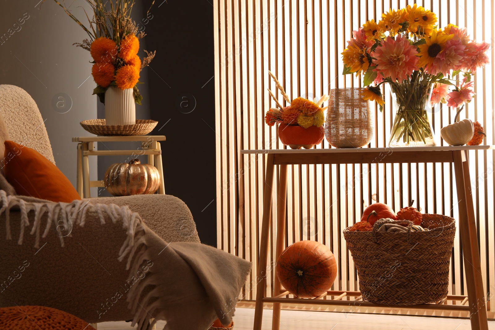 Photo of Room decorated with pumpkins and bright flowers. Autumn vibes