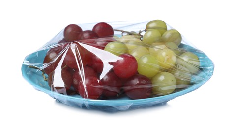 Plate of fresh grapes wrapped with transparent plastic stretch film isolated on white