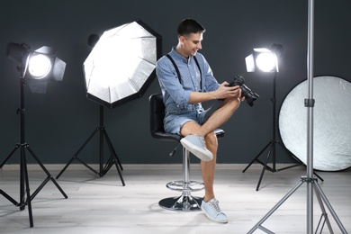 Young photographer working in professional studio