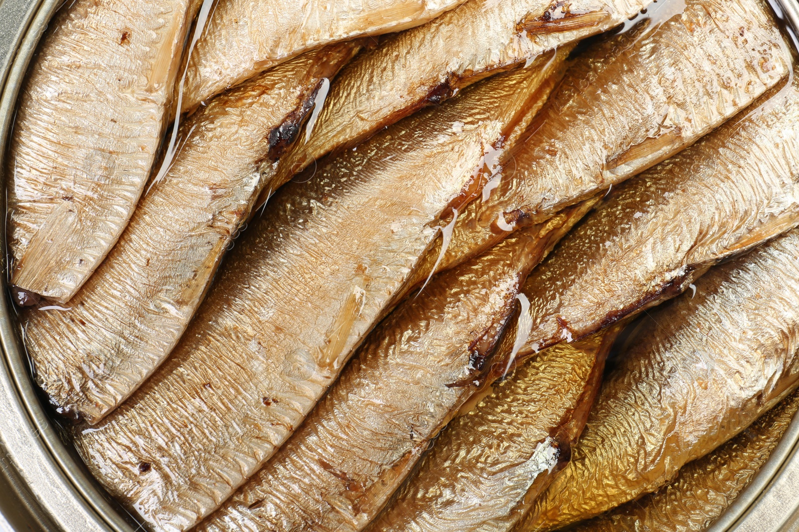 Photo of Canned sprats in oil as background, top view