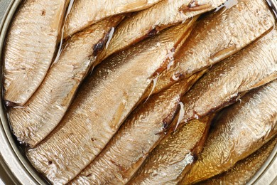 Photo of Canned sprats in oil as background, top view
