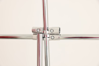 Photo of New modern metal pipes against white background