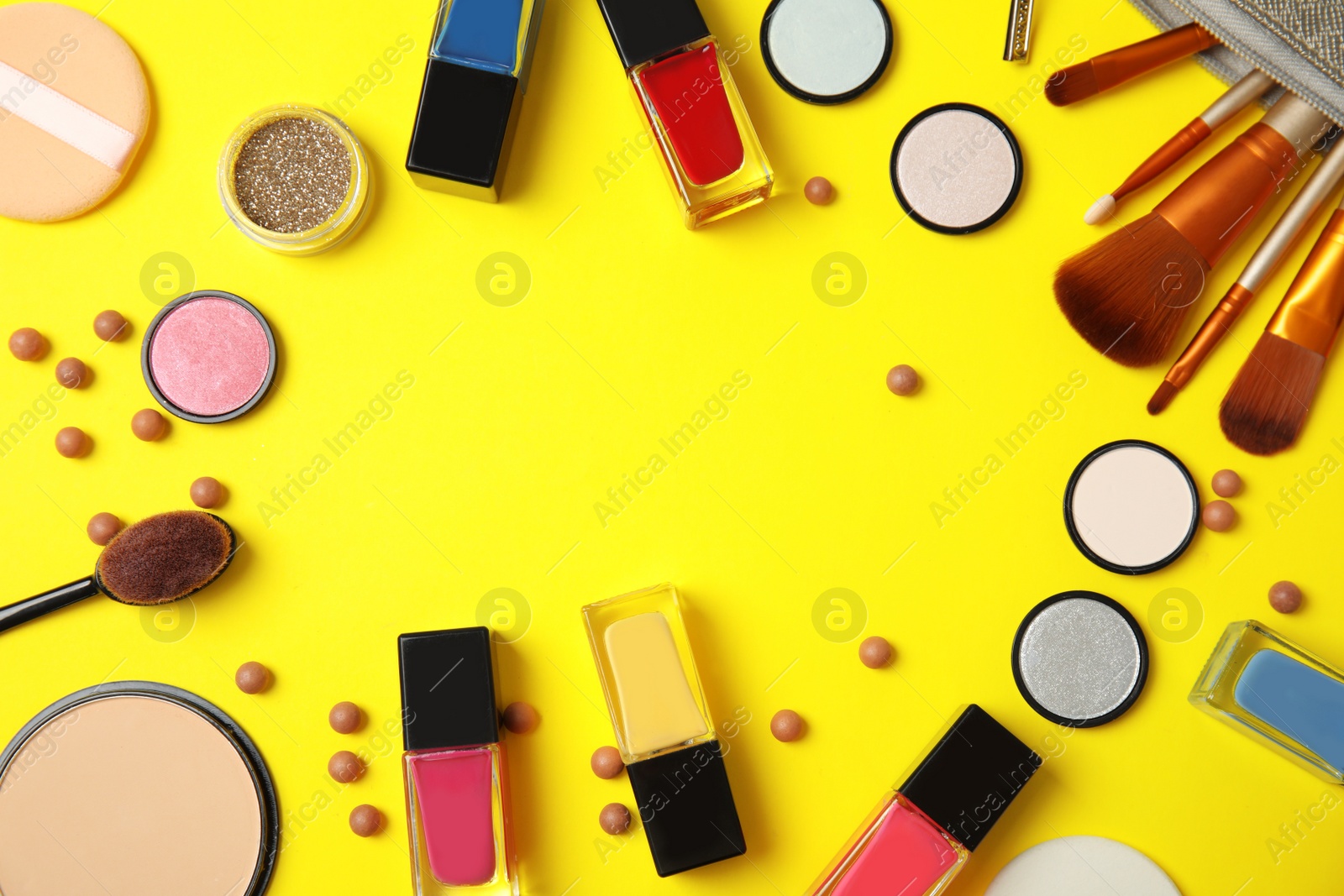 Photo of Flat lay composition with cosmetics, bottles of nail polish and space for text on color background