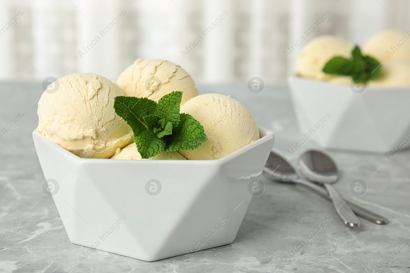 Photo of Delicious vanilla ice cream with mint served on table. Space for text