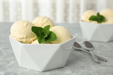 Delicious vanilla ice cream with mint served on table. Space for text