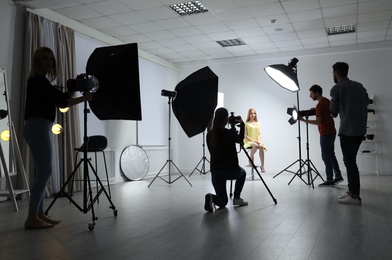 Photo of Photo studio with professional equipment and team of workers