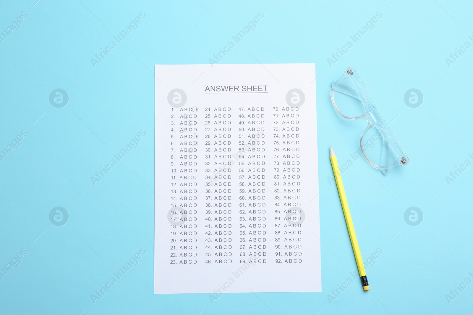 Photo of Flat lay composition with answer sheet on color background