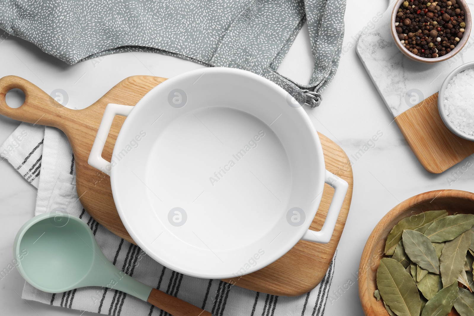 Photo of Flat lay composition with ceramic pot on white marble table