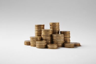 Photo of Many stacks of Ukrainian coins on white background