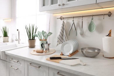 Photo of Set of different utensils and dishes on countertop in kitchen