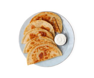 Photo of Delicious fried chebureki with cheese and sauce isolated on white, top view