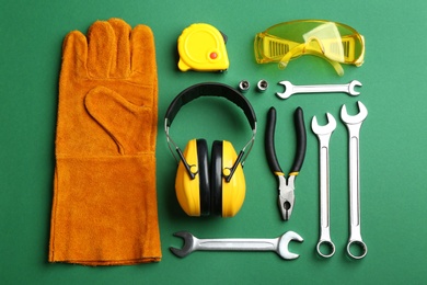 Photo of Flat lay composition with different construction tools on color background