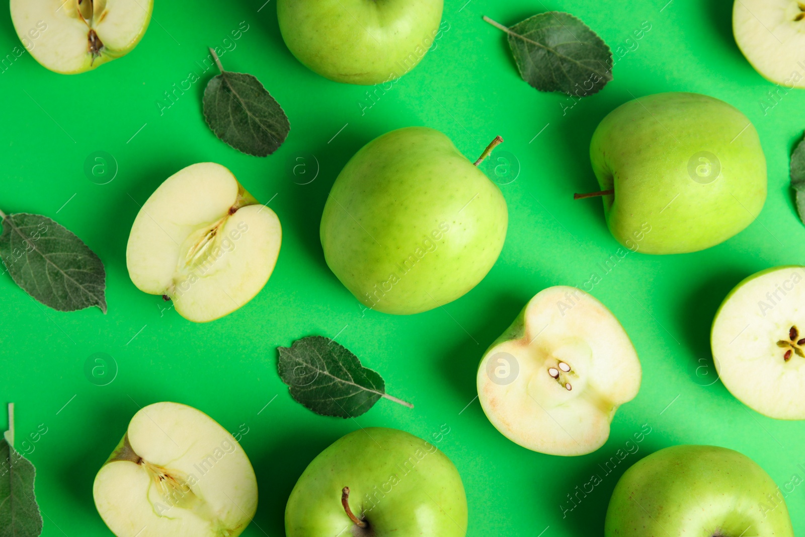 Photo of Flat lay composition of fresh ripe apples on green background