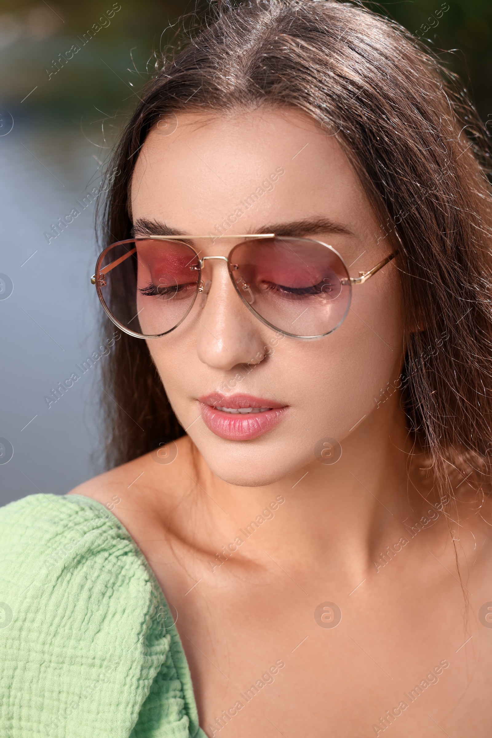 Photo of Beautiful woman in sunglasses outdoors on sunny day