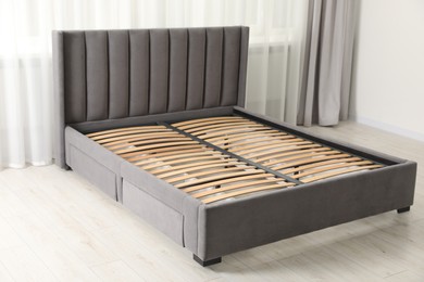 Photo of Modern bed with storage space for bedding under slatted base in room