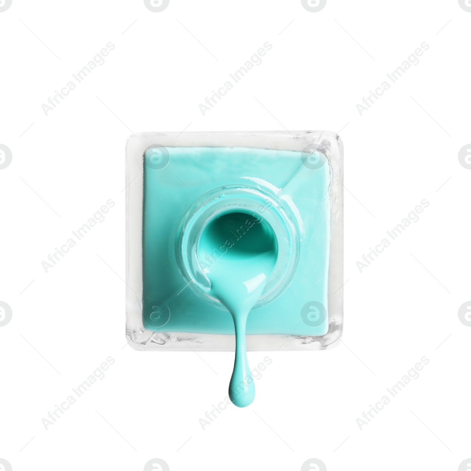 Photo of Pouring color nail polish from bottle on white background