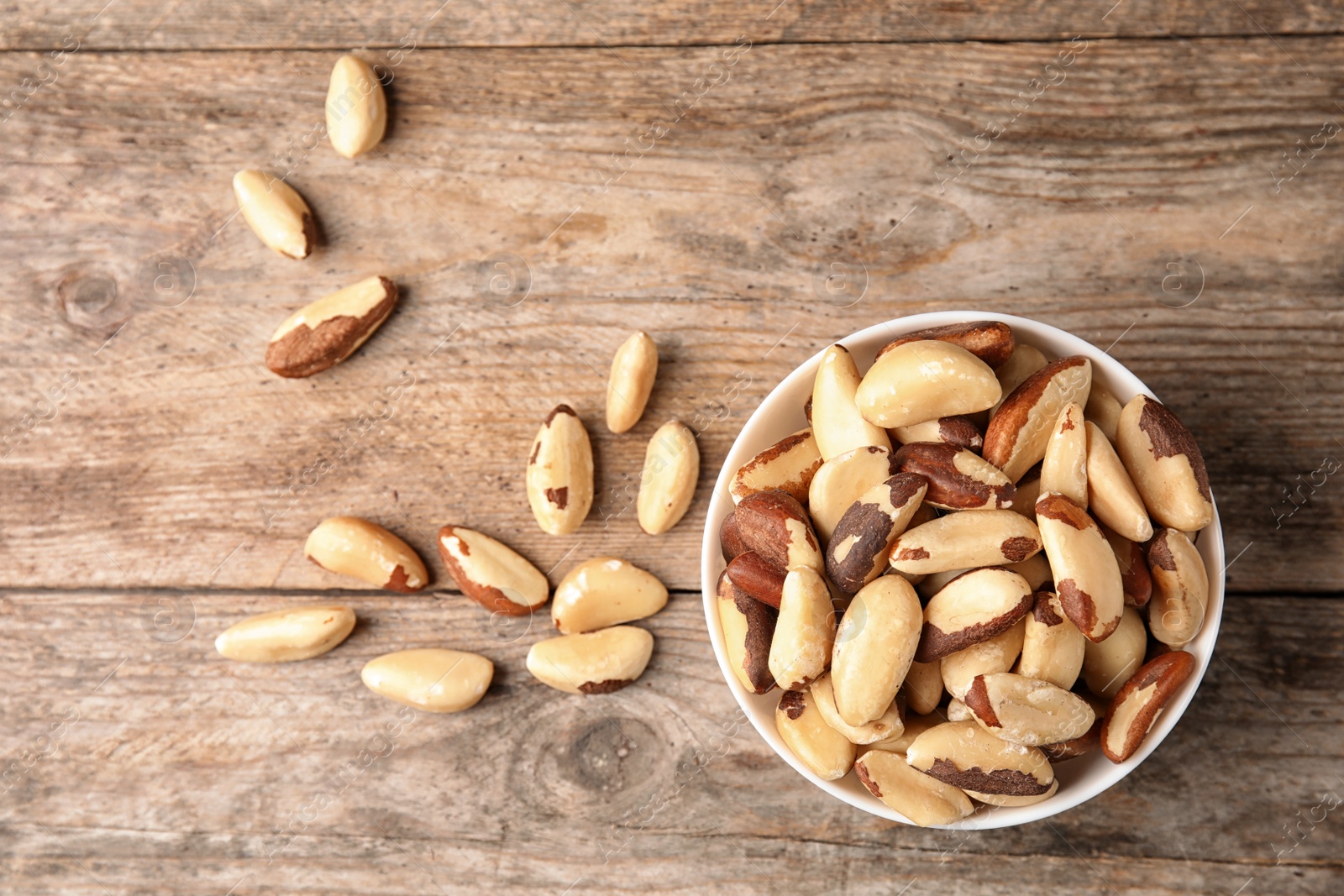 Photo of Composition with tasty Brazil nuts on wooden background, top view