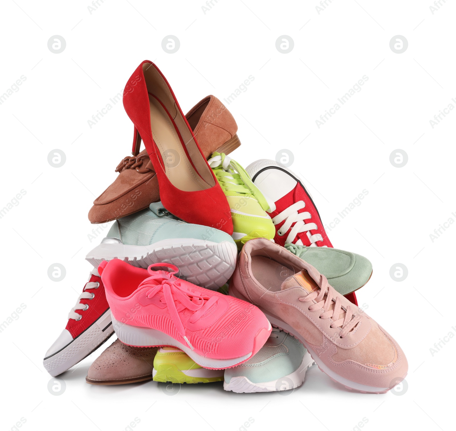 Photo of Pile of various female shoes isolated on white