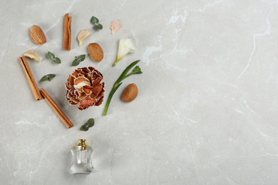 Photo of Flat lay composition with bottle of perfume on marble background, space for text