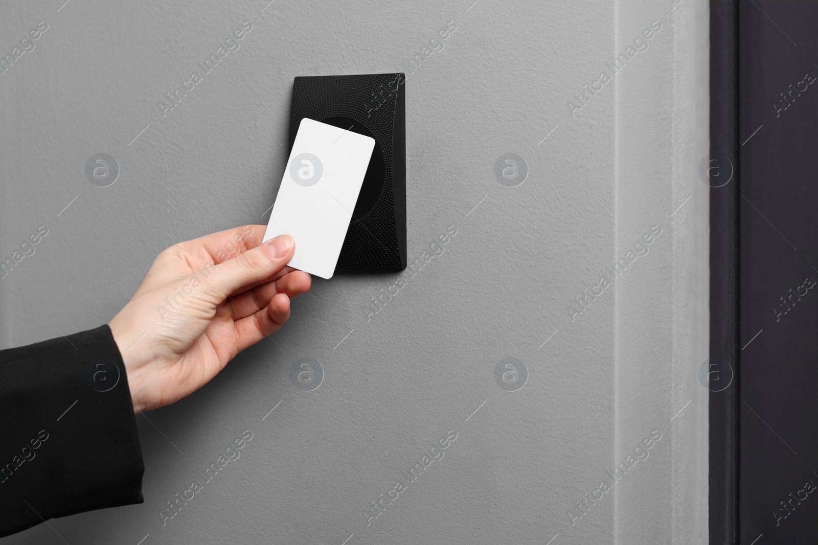 Photo of Woman unlocking door with key card, closeup