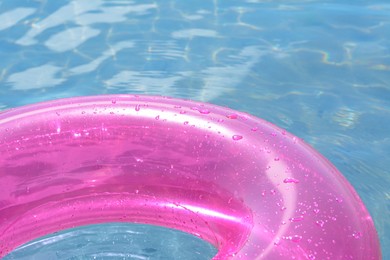 Photo of Bright inflatable ring floating on sea water, closeup