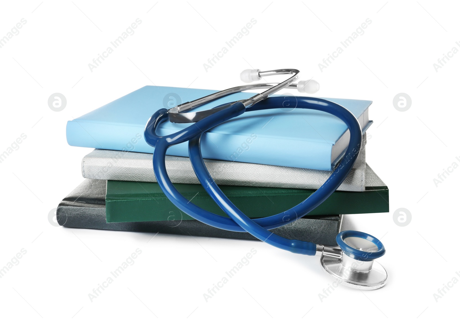 Photo of Stack of student textbooks and stethoscope on white background. Medical education