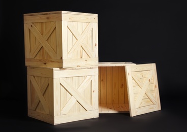 Photo of Group of wooden crates on black background