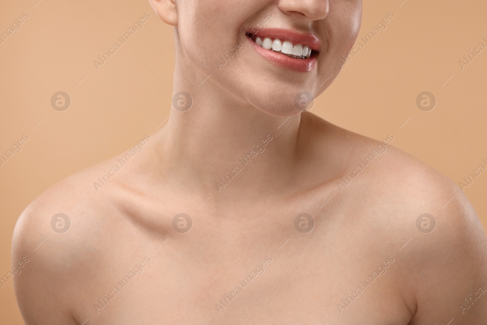 Photo of Beauty concept. Smiling woman on beige background, closeup