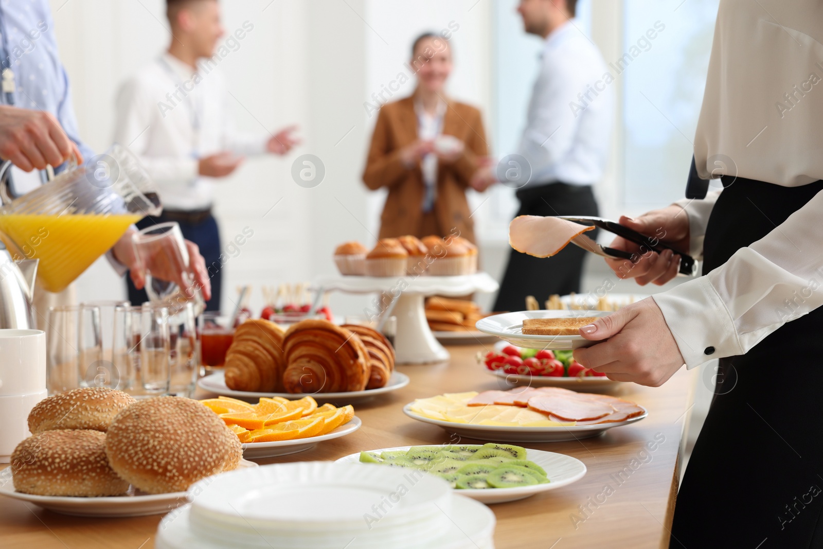 Photo of Coworkers having business lunch in restaurant, closeup