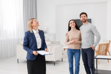 Real estate agent showing new apartment to couple