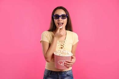 Photo of Woman with 3D glasses and popcorn during cinema show on color background
