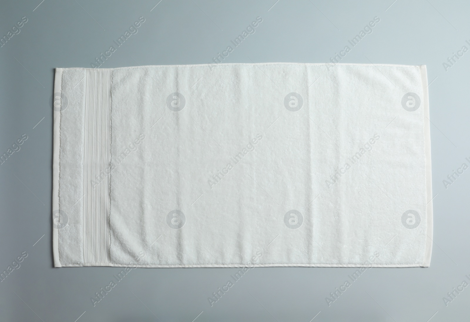 Photo of Soft towel on light background, top view