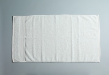 Photo of Soft towel on light background, top view