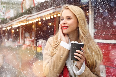 Image of Happy woman at winter fair. Christmas celebration