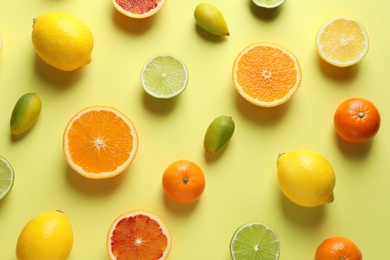 Photo of Different citrus fruits on color background, flat lay