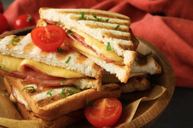 Tasty sandwiches with ham, tomato and melted cheese in bowl on table, closeup