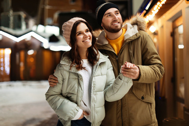 Photo of Lovely couple on city street. Winter vacation