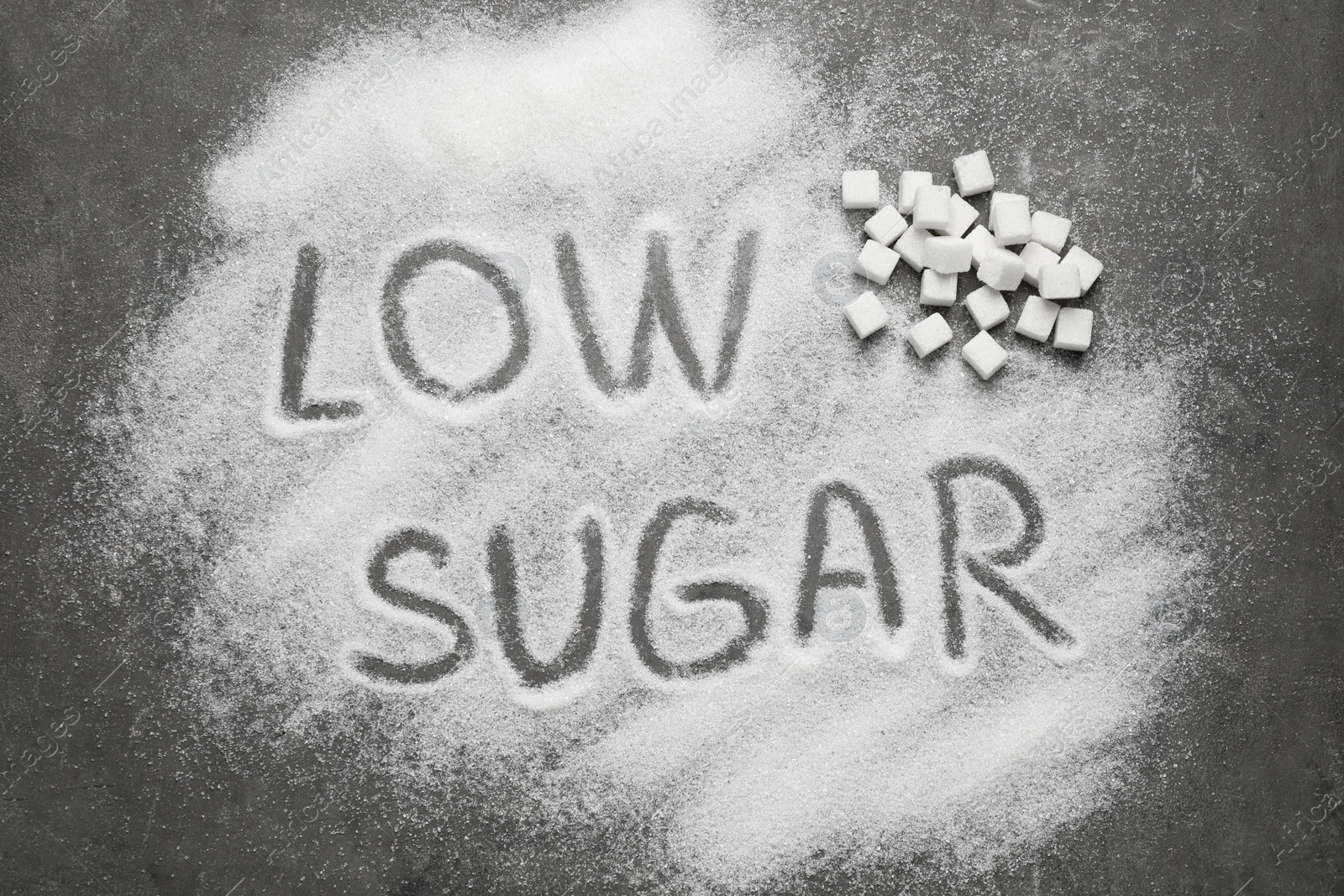 Photo of Flat lay composition with phrase LOW SUGAR on grey table