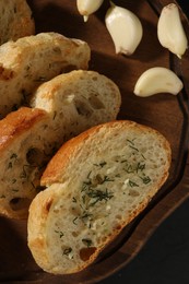 Photo of Tasty baguette with garlic and dill on grey table, closeup