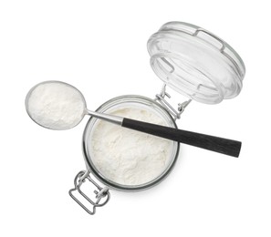 Photo of Baking powder in glass jar and spoon isolated on white, top view