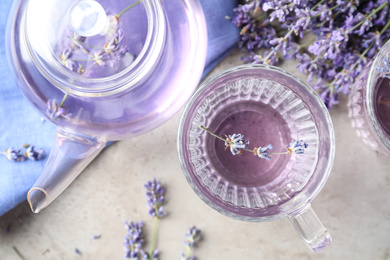 Fresh delicious drink with lavender in glass cup on grey table, flat lay