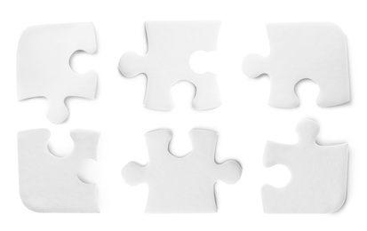 Image of Set with jigsaw puzzle pieces on white background, top view