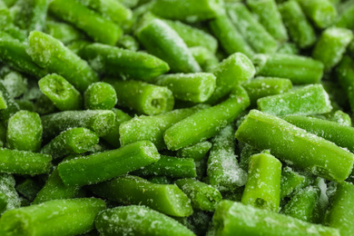 Photo of Frozen green beans as background, closeup. Vegetable preservation