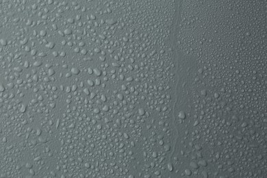 Photo of Many water drops on light grey background
