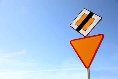 Photo of Different road signs against blue sky. Space for text