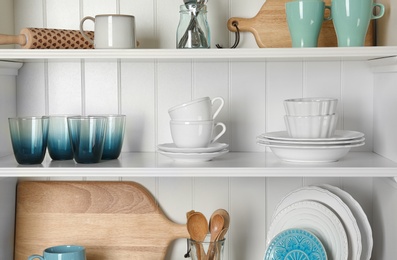 White shelving unit with set of dishware