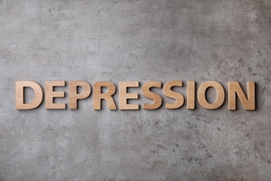 Photo of Word Depression made of wooden letters on gray background, top view