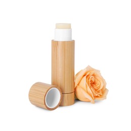 Photo of Lip balm and rose flower isolated on white